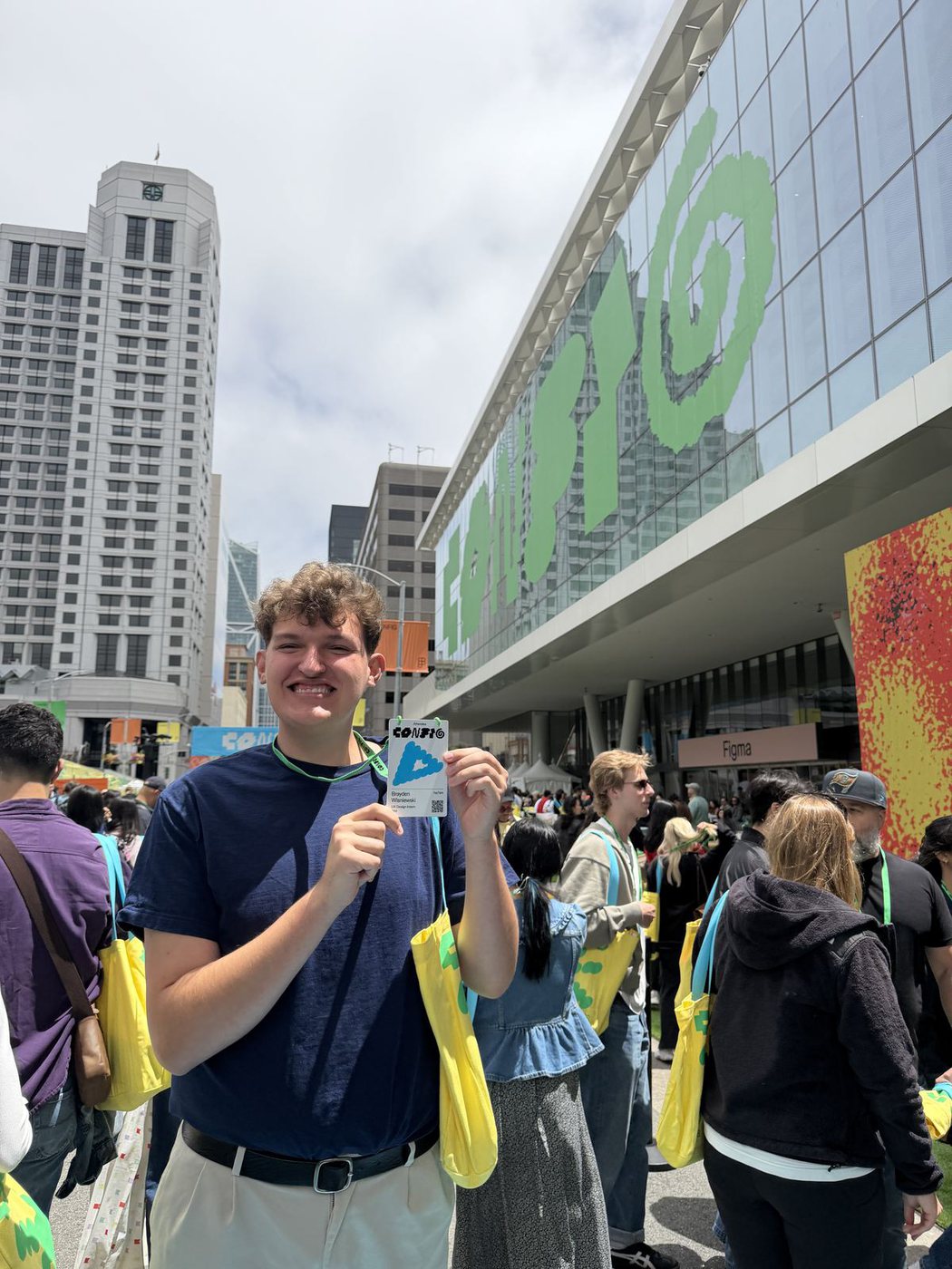 Brayden holding his Config badge outside the conference in San Francisco